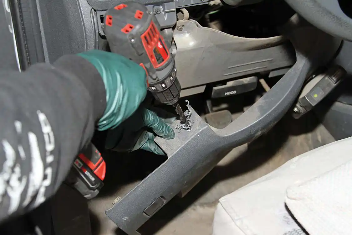 Then he drills the mounting hole in the panel for the CSP5 switch.