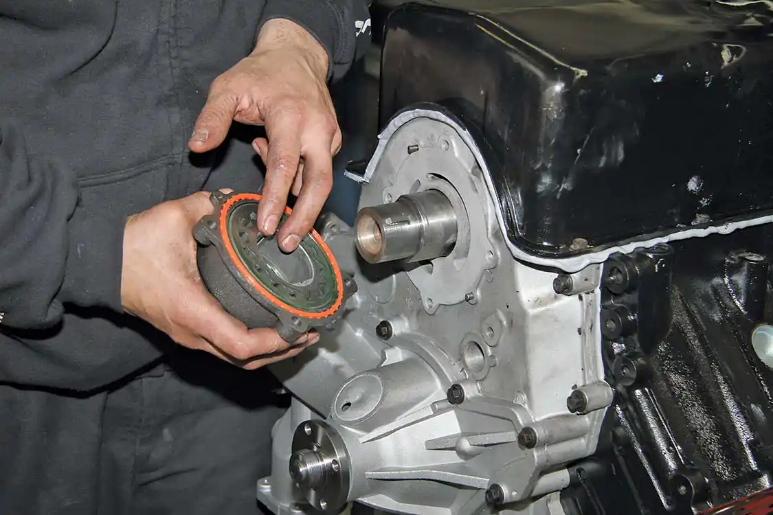 With the engine upside down, the front cover and a new Alliant Power water pump are installed.