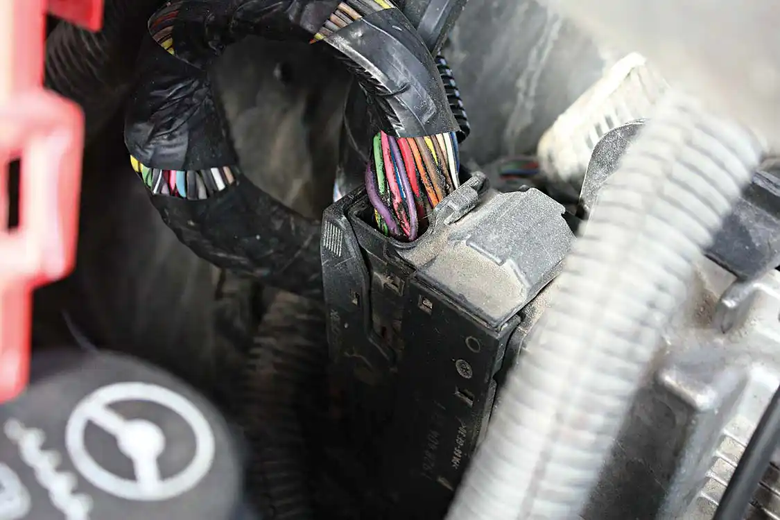 Once the DSP5 switch is installed in the cab, the wires will be routed to this main ECM harness connection location.