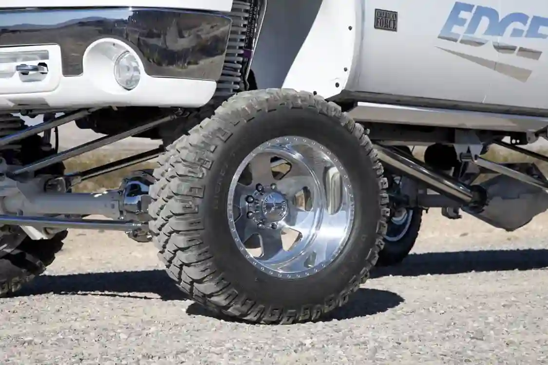 This GMC rolls on a set of Mickey Thompson 36x15.5x20 MZT tires mounted on 22x14 American Force Judge SS8 polished wheels