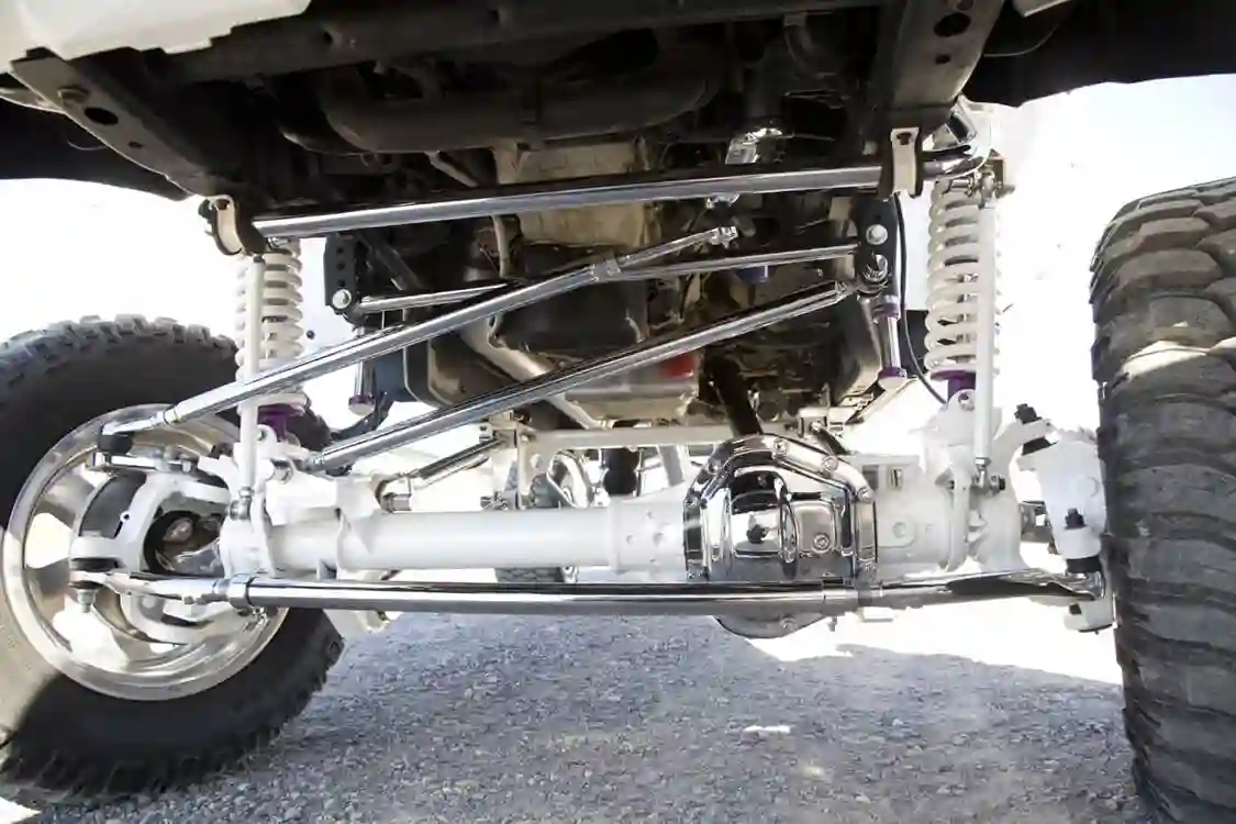 Yep, that’s a Dana 60 straight axle under the front end. It’s made possible due to the new TCS suspension. The 7-inch TCS Suspension four-link kit is said to be 100-percent bolt-on, with no welding or cutting required. As you can see, the sway bar, tie-rod and steering links were chrome plated. The new front axle and some other components were painted bright white. 