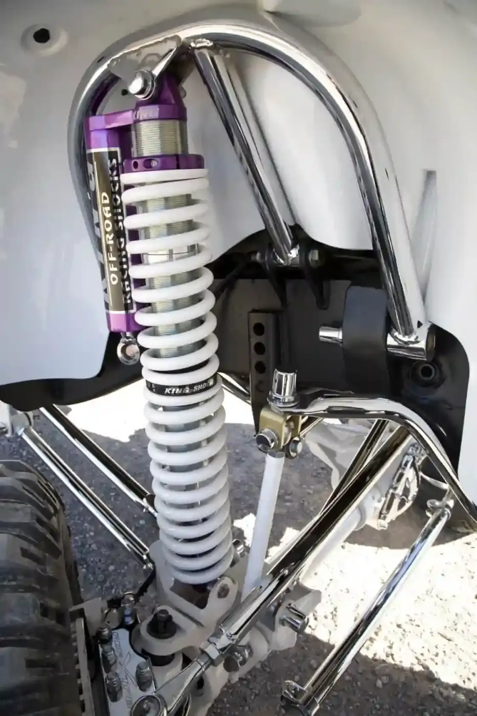 The front shocks are King coilover units with an attached reservoir. Coilover shocks offer superior dampening. Their design provides a space-saving solution that allows these shocks to be both the suspension spring and the shock absorber in one package. Notice the two-stage spring setup; this makes fine-tuning the suspension easier, and offers a better ride, too. King bump stops are also used on this suspension setup. Of course, the shock hoops are chrome plated.