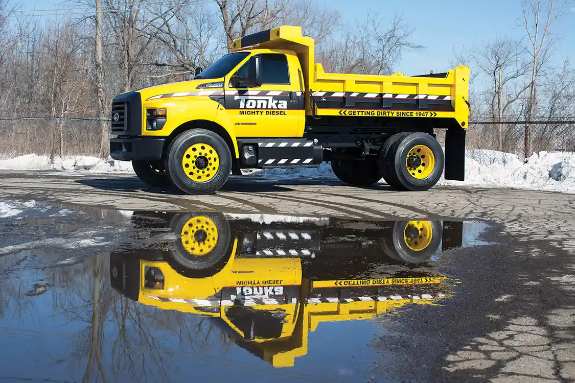 Based on the all-new 2016 Ford F-650/F-750, the Mighty F-750 TONKA dump truck is is painted signature TONKA yellow with a custom blackout nostril grille and fully functional dump body from Truck Tech Engineers.