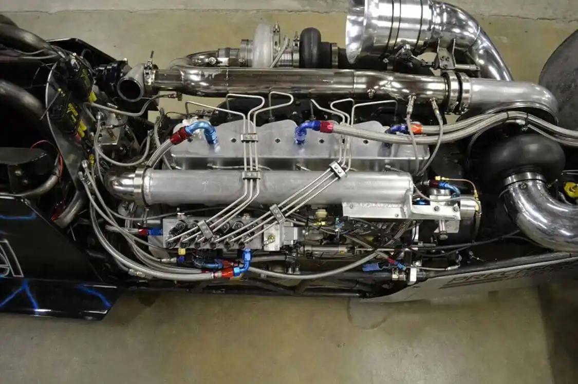The 2,500hp Cummins in the Scheid dragster is a marvel of modern diesel engineering. It features a <a href="https://fluidampr.com/">Fluidampr</a> and mounting system of Dan's own design, a 6.7L crankshaft, Scheid connecting rods, and <a href="https://ariaspistons.com/">Arias</a> 12:1 compression pistons to arrive at 6.4L of displacement. Valve actuation is courtesy of a Scheid roller camshaft, and above the fire-ringed block lies a heavily ported cylinder head from <a href="https://hamiltoncams.com/">Hamilton Cams</a>, with 225-pound valve springs. The long block is good for a whole season's worth of 6,000rpm passes.