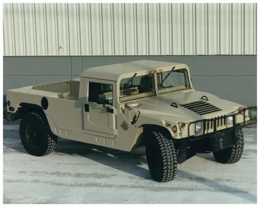 A Hummer H1 in pickup/flatbed two-door configuration. Hummer platforms feature a four-wheel fully independent suspension system complete with heavy-duty springs and hydraulic shock absorbers. Specially designed geared hubs provide a unique gear reduction of 2:1 at each wheel end, doubling the torque output.