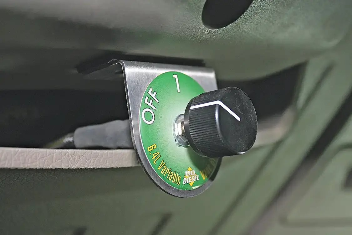 11. The VVT system is controlled in-cab with a three-position switch that can be mounted just about anywhere the owner prefers. The small bracket offers endless mounting possibilities, but directly under the steering column offered the easiest reach without being in the way or requiring any drilling. Running the switch in “off” allows the turbos to work like stock. Position One is Vane Control only for mild engine brake, while Position Two offers a Vane Control along with a more aggressive transmission downshift pattern to maximize engine braking.
