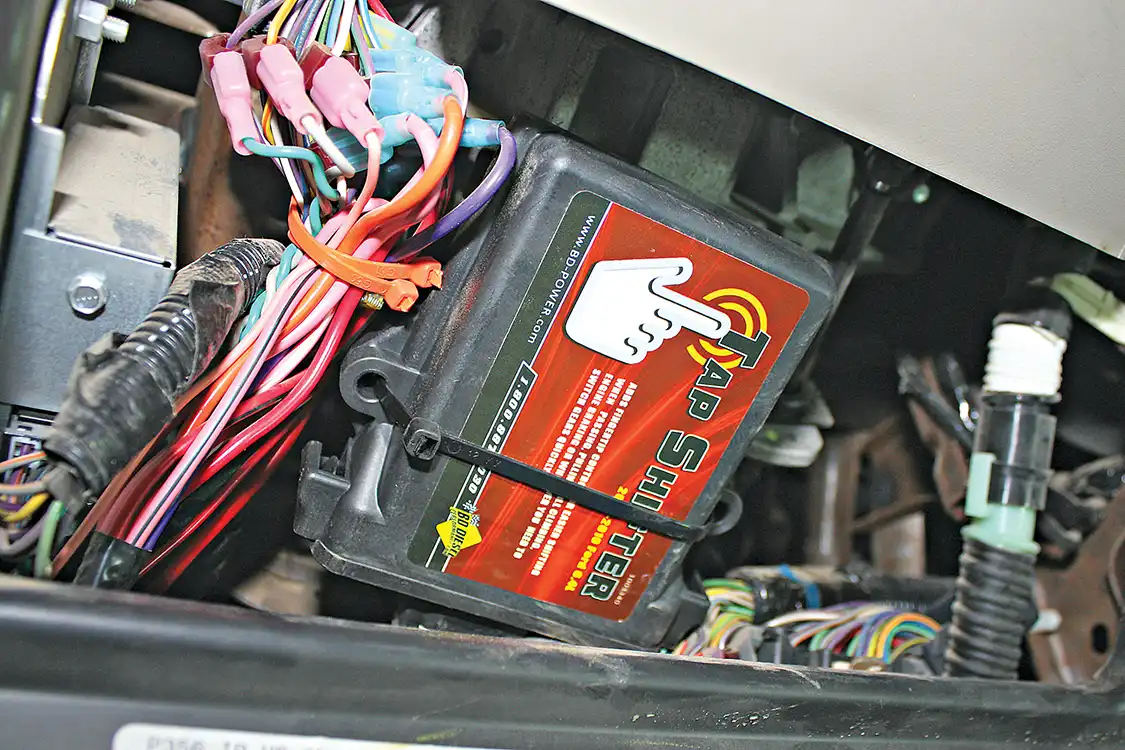 3. The Tap Shifter control box mounts under the dash and includes a professional-grade wiring harness to make the installation virtually plug and play. The kit will piggyback the factory OBD-II port and shift selector pigtail. There's one wire down along the frame that will need to be spliced and tapped into the BD module.