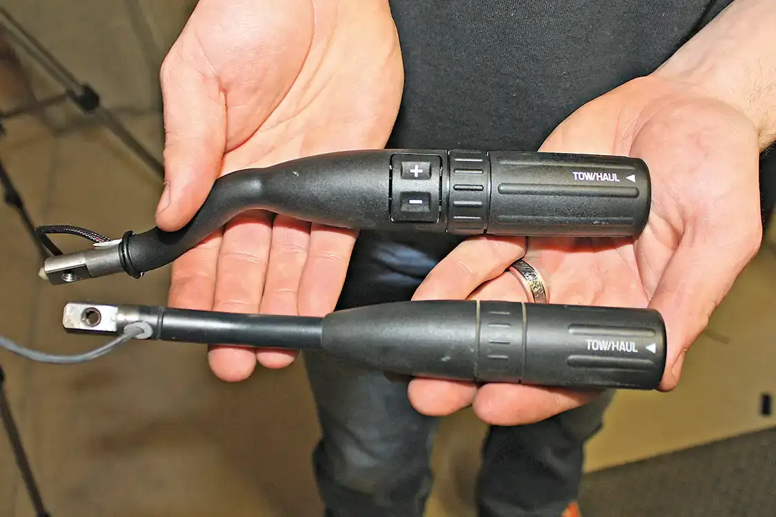 7. With the stock lever removed, you can see the similarities and differences. While the obvious +/- button is the biggest difference, the bend in the lever is slightly different as well, which will put the lever in a little different location. The built-in Tow Haul button will still function like stock and allow the transmission to adjust shift pattern and converter lock-up to take better control of heavy loads when accelerating and decelerating.