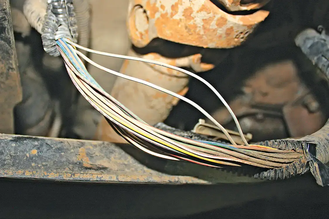 8. The only real wiring required with the Tap Shifter kit happens under the truck along the transmission crossmember where the main transmission wire bundle is routed. Here, you’ll remove the factory shielding to gain access to the big bundle of wires that send all electronic signals to and from the transmission. The BD module will splice into the gray/brown tracer wire, but be sure to pay attention as there are two wires in the bundle with that color combo—one a smaller 20ga, the other a thicker 18ga wire. You’ll be tapping into the smaller of the two.