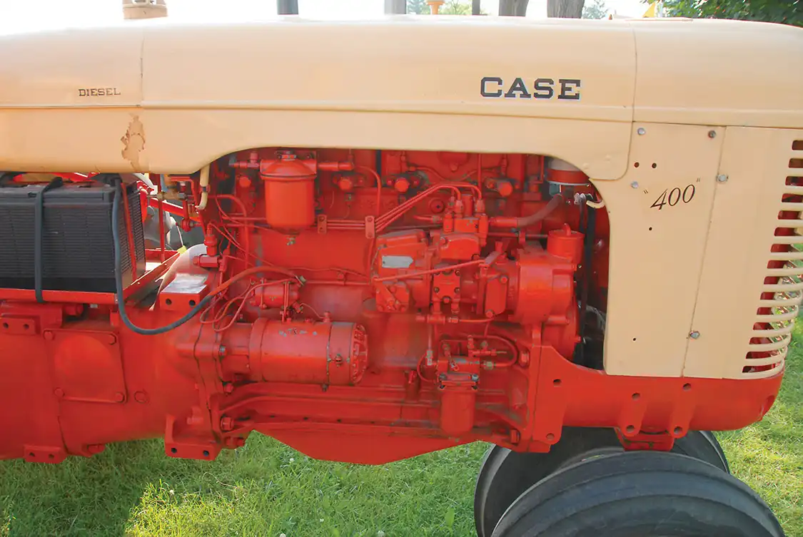 On the pump side of the 251D, you can see the American Bosch PSB series pump, the dual fuel filters and the paired cylinder heads. Paired heads were not unknown in the era, but were unusual. The heads were shared with the 377-cid six and made for a lot of production commonality for Case. The sleeves, pistons, rods, bearing shells, timing gear and many other parts were in common. You can also see the injectors, which are mounted horizontally on a Lanova engine. This engine bumped to 267 cid in 1957 with an 1/8-inch bore increase, but farther down the road it jumped again to 284, 301 and 336 displacements with bore and/or stroke dimension increases. This basic engine was in use and produced into the 1990s.