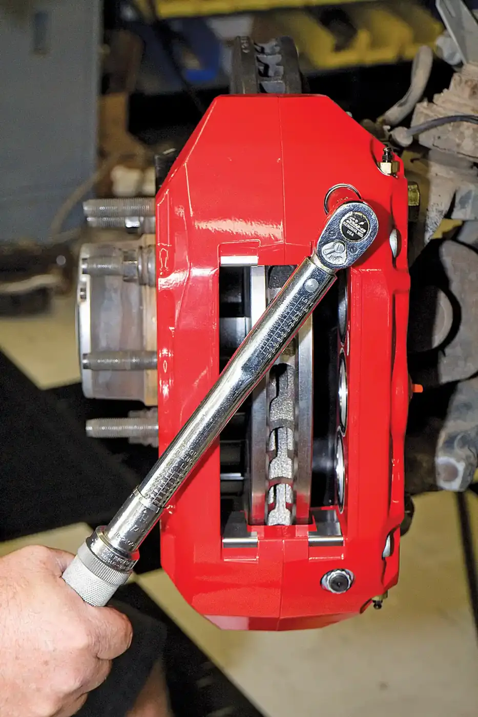 8. With the brake calipers centered on the rotors, the caliper mounting bolts are torqued to spec. 