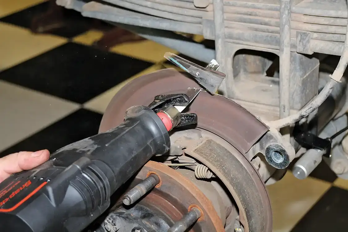 13. It is easier to start to trim the rear dust shield by starting at the seam line with some tin snips. Finishing it is easier with a metal blade on a saw.