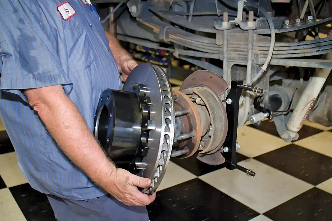 14. As with the front, the Wilwood rear-rotor and hat assembly must be put together. At the rear, the hat is also the parking brake drum. Be sure to install the caliper bracket first. Also, be sure to check the parking brake shoes and change them if needed.
