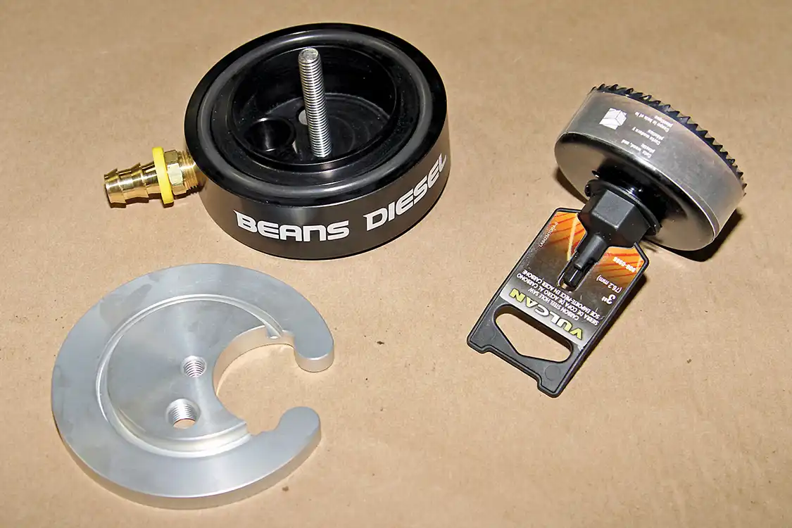 5. Rather than sucking fuel out of the top of the tank, we also installed a Beans Diesel Performance fuel sump to let gravity help us get the fuel from the bottom of the tank. The kit even includes the properly sized drill hole in the bottom of the fuel tank.