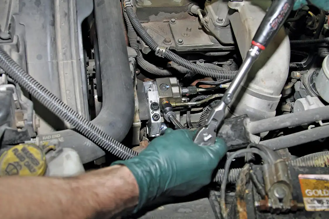 12. Grubb reinstalled the factory outlet and return lines on the new Fleece CP3, but left the inlet capped for now as he will be running a new hose from the AirDog pump directly to the CP3.