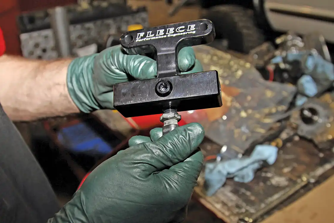 14. Remove the WIF sensor from the factory filter housing and reinstall it into the Fleece delete block. Then the filter delete block can be installed by connecting the fuel lines to it using the original banjo bolts with the supplied copper washers. Once the banjo bolts are tightened, the block can be secured to the engine.