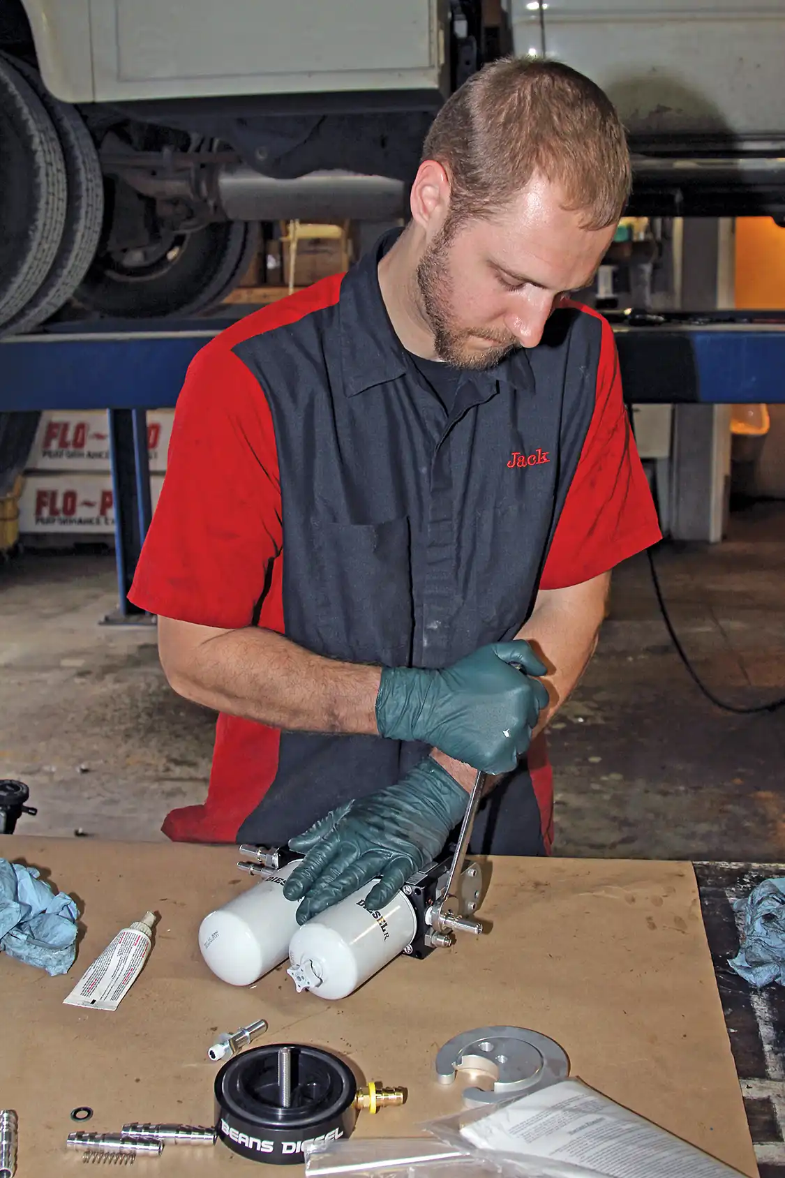 16. After raising the truck, Grubb drilled a small 5/16-inch hole where the BDP sump would be installed to start draining it. While the tank was draining into clean five-gallon buckets, Grubb installed the fittings on the AirDog system and assembled the pump mounting brackets.