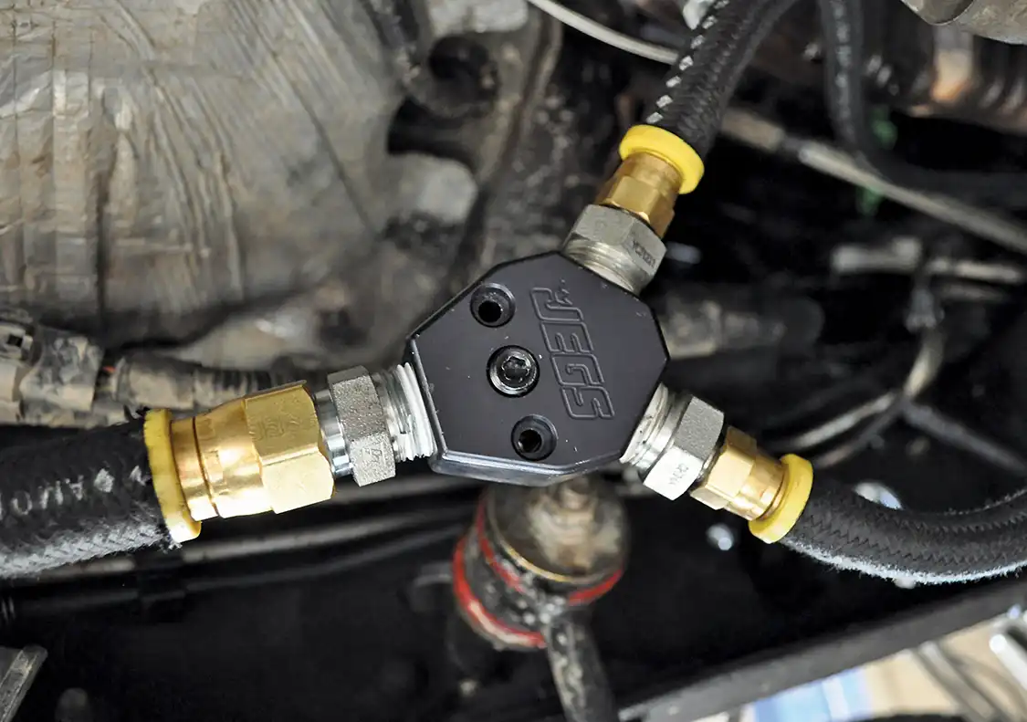 4. Each 3/8-inch line then runs down to a union fitting that Lezama chose to mount on the frame below the driver's seat. He chose this location due to its ease of access. If there's ever a problem, it will be much easier to fix than if it were up in the engine bay where it's more cluttered.