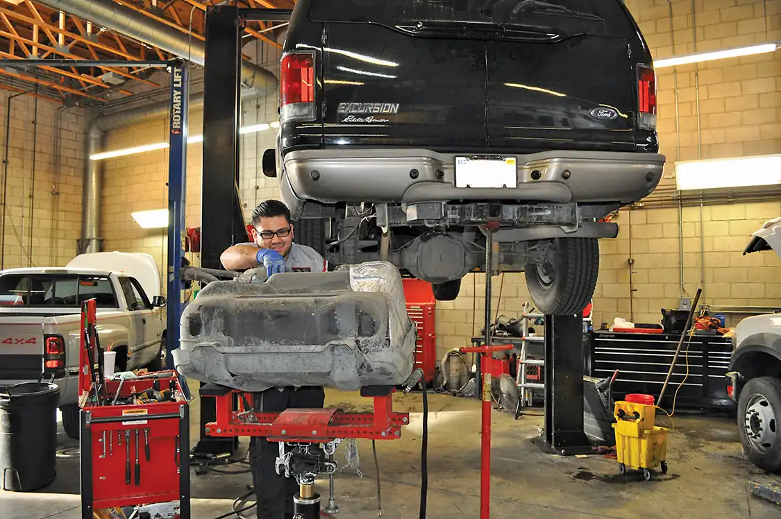Next, Lezama dropped the tank to install the new draw straw and fuel return fitting.
