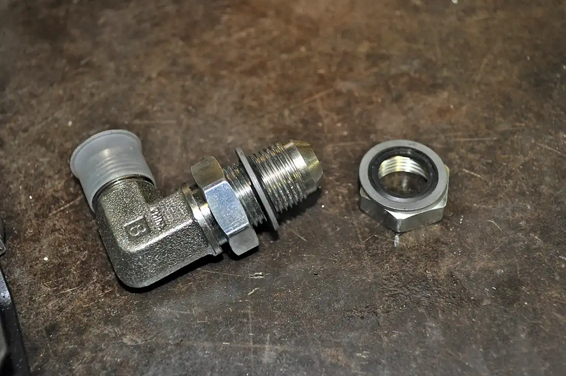 18. HSp supplied us with this fitting for the return. It uses two O-ring washers, one on either side of the tank, to provide a tight seal. HSP recommends using a small amount of silicone sealant as well to help ensure a perfect seal. The pick-up tube also utilizes this type of seal.