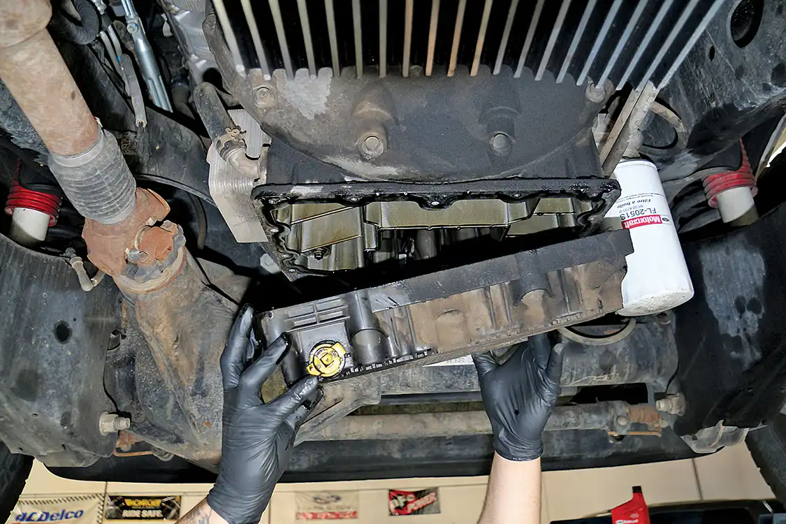 3. Our mechanic, Byron Hermosillo, drained the pan, reinstalled the plug to stop most dripping and then removed it from the engine. 
