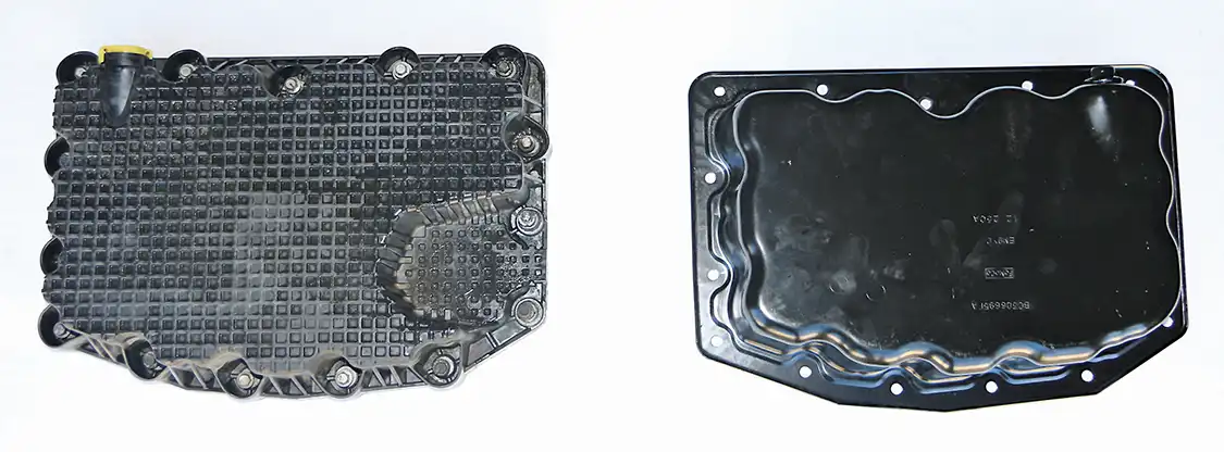 6. This view shows the outside of the composite pan (left) and the new stamped steel pan (right). The composite pan has a raised section opposite the drain plug. Without this, the steel pan holds a pint (1/2-quart) more oil. Also, notice that the composite pan has integrated bolts, which can’t be reused with the steel pan. 