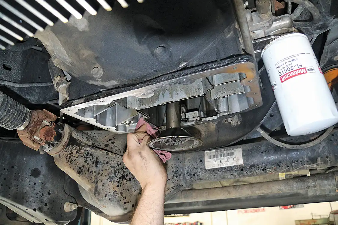 8. After removing the pan, Hermosillo wipes out the oil in the engine skit and then lets it sit for a while, so the oil in the engine can drip out into the catch pan. He then wipes it off again before installing the new pan, as any stray oil drips on the sealing surface during reassembly can cause a leak later.