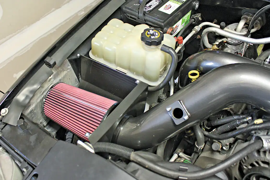 10. The final piece of the puzzle is the hand-fabricated airbox and 4-inch, mandrel-bent intake pipe that routes clean, filtered air into the mouth of the new turbocharger. The complete system comes powdercoated in your choice of color, so it not only improves performance, but looks incredible doing it.