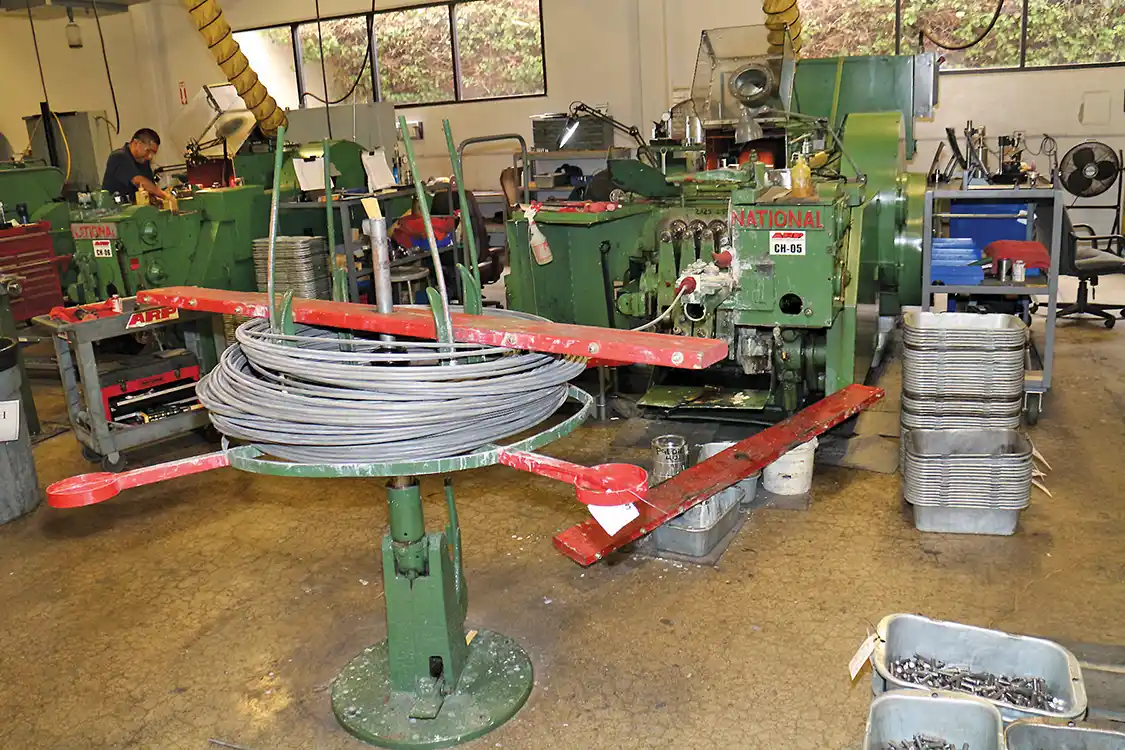 Here you can see a coil feeding into a cold header machine. No additional heat is used in this process.