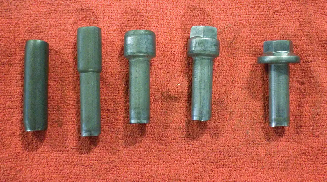 The cold heading process takes coil wire (L) and forms it into a basic bolt head (R). Four stations are needed to get the coil wire into the necessary form for the bolt making process.