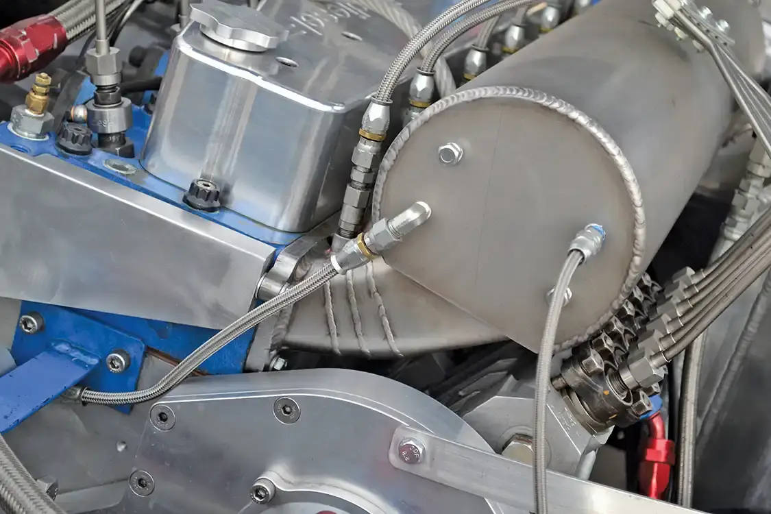On the original Cummins, the intake is a simple "shelf" design that connects all the cylinders on a single log, but Jason required a more precise approach. On the intake side of his pulling engine, boost from the turbos heads into an individual-runner intake, which funnels an equal amount of air into each cylinder. 