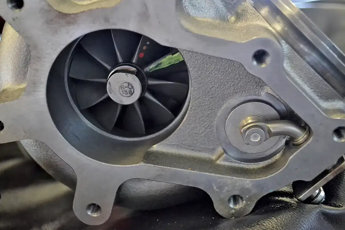 If you notice a funny-looking flange coming off the exhaust of some turbos, it’s because they have internal wastegates. An internal wastegate (arrow) is used to bypass the turbine wheel if drive pressures get too high.
