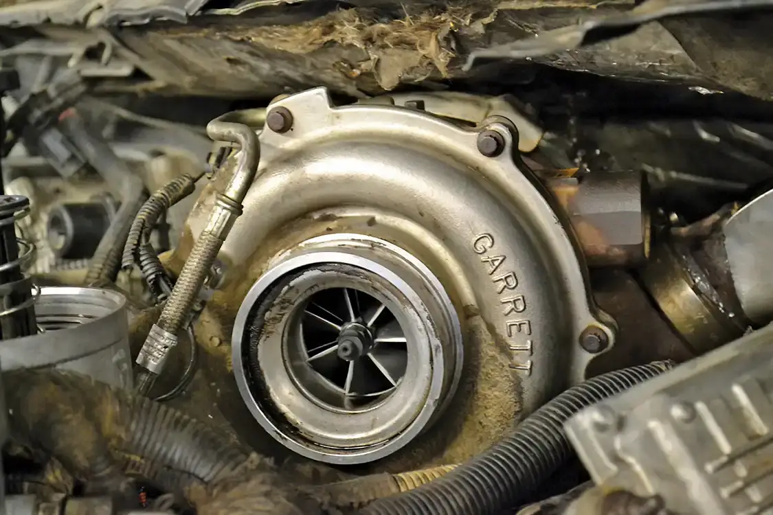 Turbos can lead a hard life, as evidenced by this grime-covered unit tucked under the firewall. Still, due to their simplicity, outright failures aren't very common in most engines.