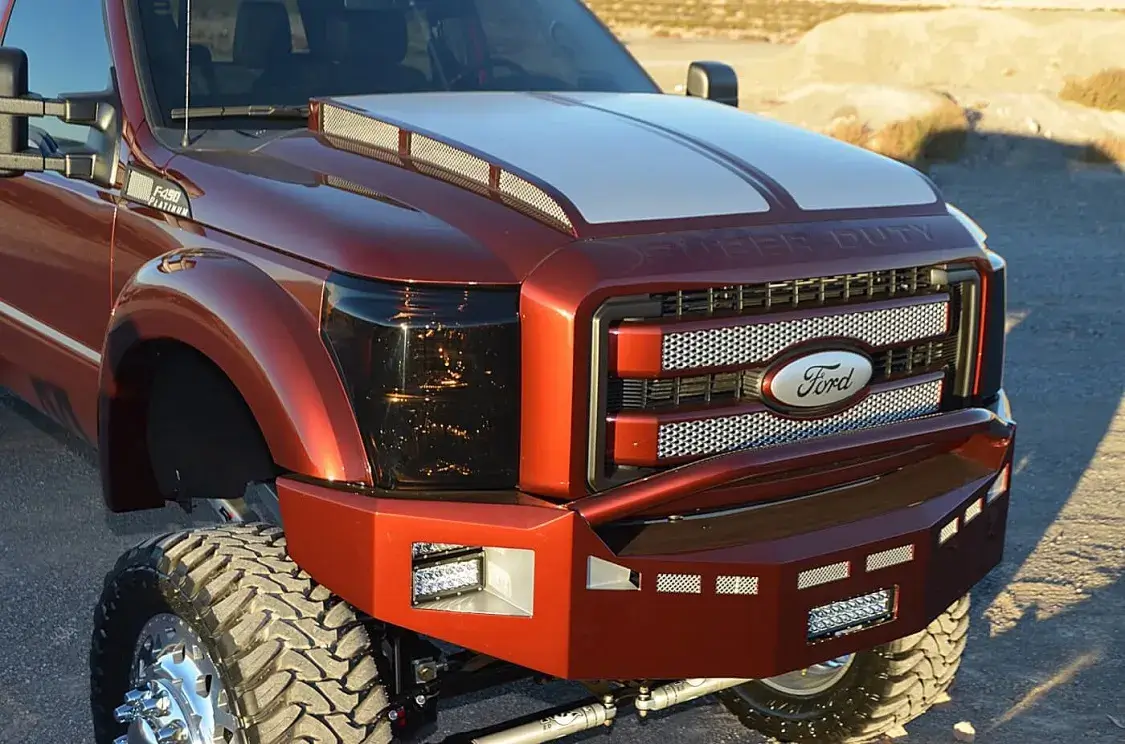 This custom-built hood started with the original 2015 hood and had the center cut out and replaced by part of a 2001 hood, creating a stylish cowl hood with side screening to match the billet Street to Sand side emblems.