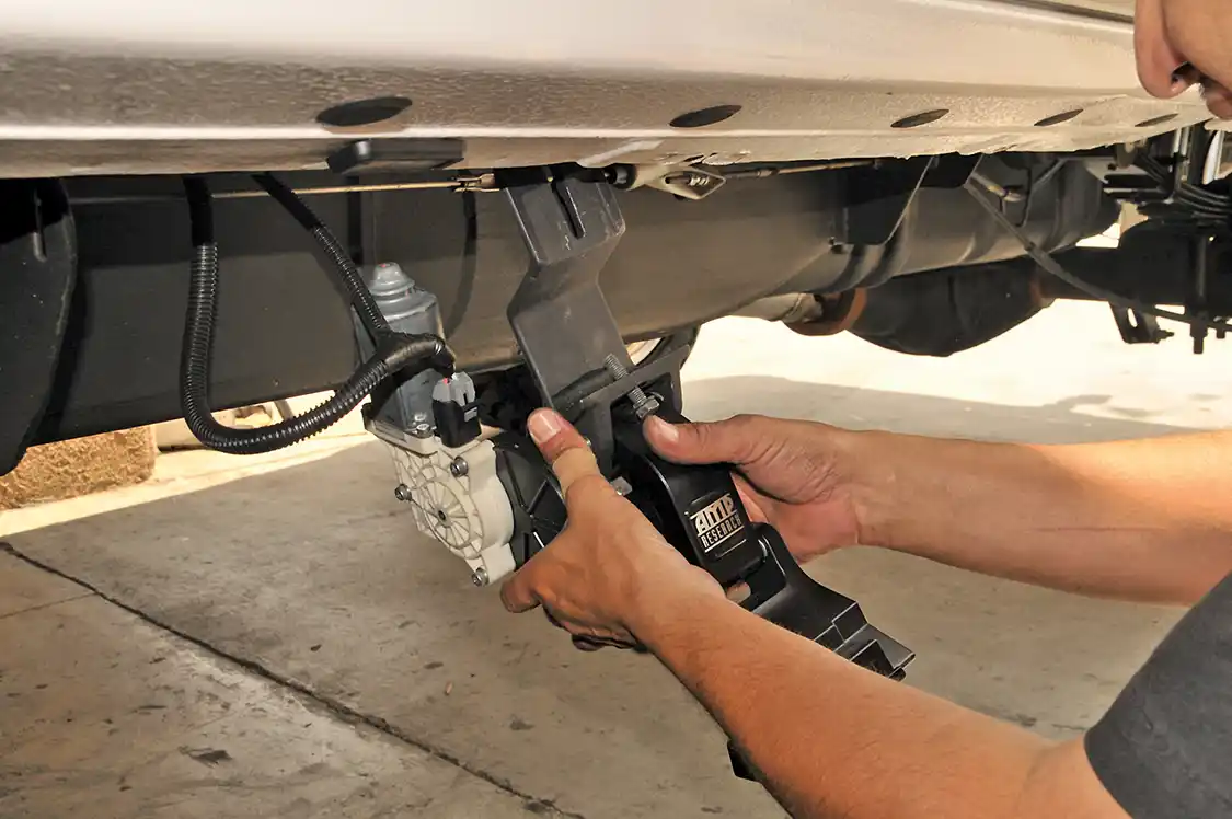 20. Next on the agenda was a set of electrically operated <a href="https://www.amp-research.com/">AMP Research</a> power steps. The power hinges are the first things to be installed. Luckily, they use some available holes in the truck, so locating the proper position is easy.