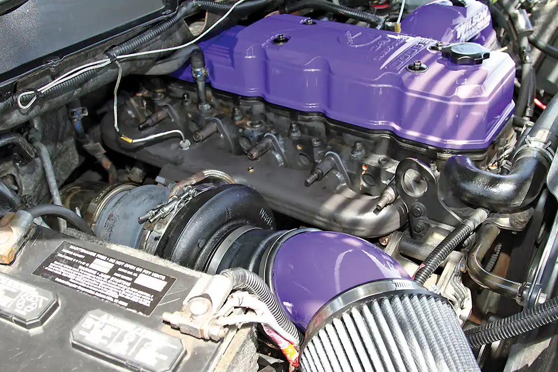 The passenger side of the 5.9L Cummins is dominated by a Steed Speed manifold and a Fleece Performance Engineering S468 turbocharger.