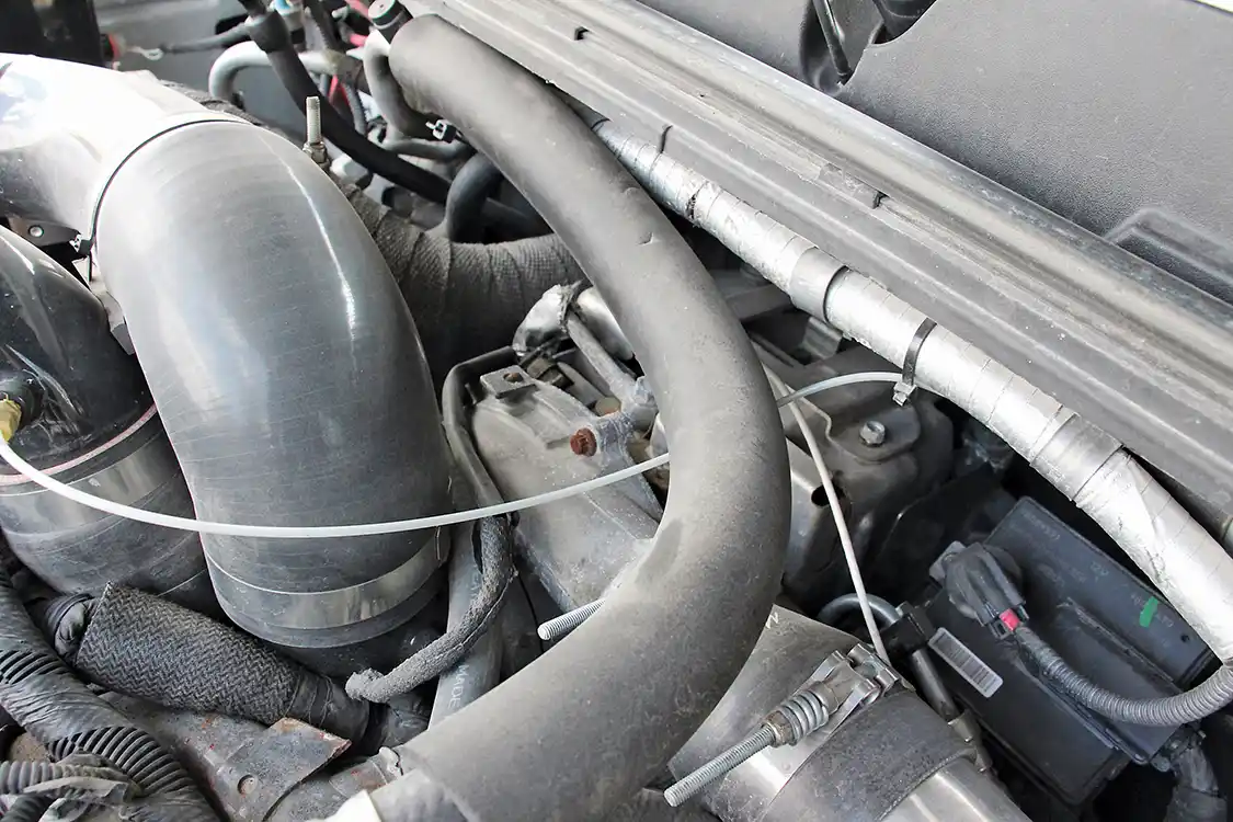 Tucked away in the factory location rests the first aftermarket turbo Kaden purchased: a 2.5-inch (63mm) charger from Danville Performance. The stock appearing VGT Garrett is the key to the truck’s quick spool up, and when combined with the S475 mounted in front of it, 55 psi of boost is made at full tilt.