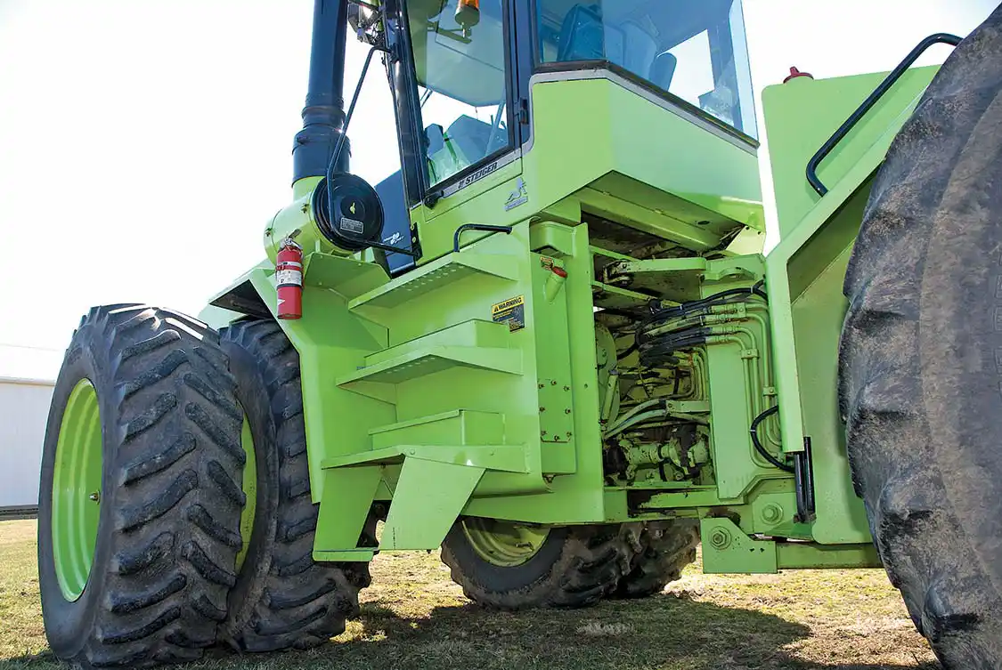 The pivot point of an articulated tractor is where a lot of stuff happens: Not only is there power transmission to the rear axle via huge universals, a lot of hydraulics transfer as well. You will note that the forward end of drawbar attaches just before the pivot point. Those two pivots carry a lot of torque, so maintenance is important to avoid an extensive and expensive repair.