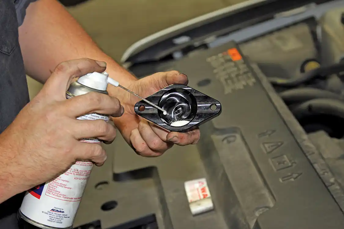 4. Before installing the machined billet aluminum delete plate, the technician sprays lubricant on the inside and runs it around the inner edge with his finger to prevent it from snagging on the O-ring as it’s installed.