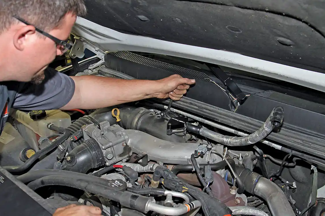 10. The other end of the PCV hose is bolted to the turbo intake near the resonator delete plate as seen here.