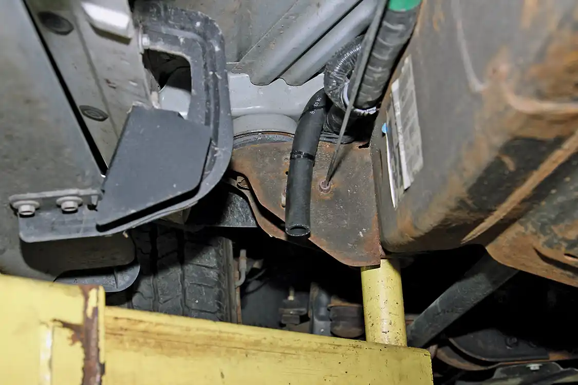 19. Lift the truck on the hoist and go under it to route the hose to the outside of the frame, and then secure it with the zip-ties provided in the kit.Installing a vented catch can with a drain and breather filter would be a good addition to the PCV reroute especially for anyone interested in drag racing their truck. 