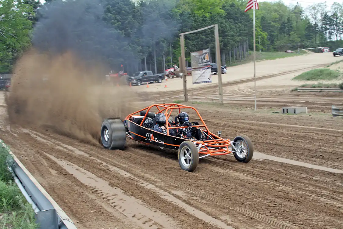 One of the many raffle winners getting the ride of her life in the Merchant Automotive sand rail.