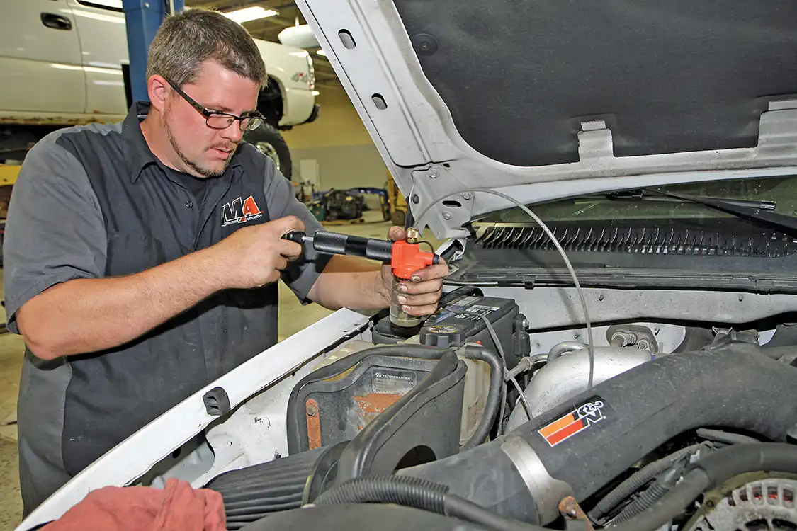 4. Phaff used a vacuum pump to draw oil out of the engine through the dipstick tube without draining the oil from the pan. This is a clever method for analyzing oil between changes when draining is not needed.