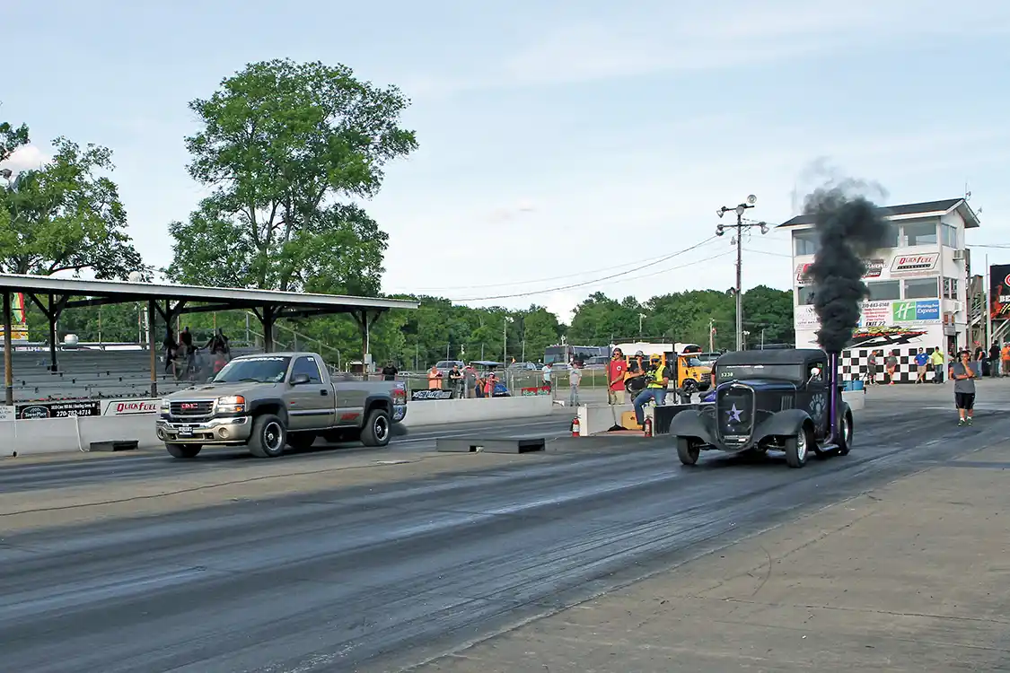 Vince Neiderhauser (far lane) drove his GMC to a 12.013-second pass in the final round of the 12.0 Index Class, taking the win over Susan Stump and her Rat Rod when she crossed the finish line first but broke out with a 11.975-second pass.