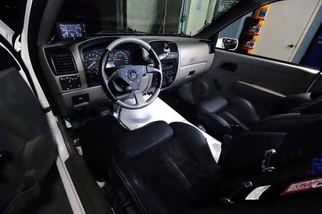 The interior is mainly stock outside a few modifications. the transmission tunnel was redone to give room for the new Allison 1000. A GT steering wheel was installed, as was an <a href="https://edgeproducts.com/">Edge</a> CTS to monitor engine vitals.