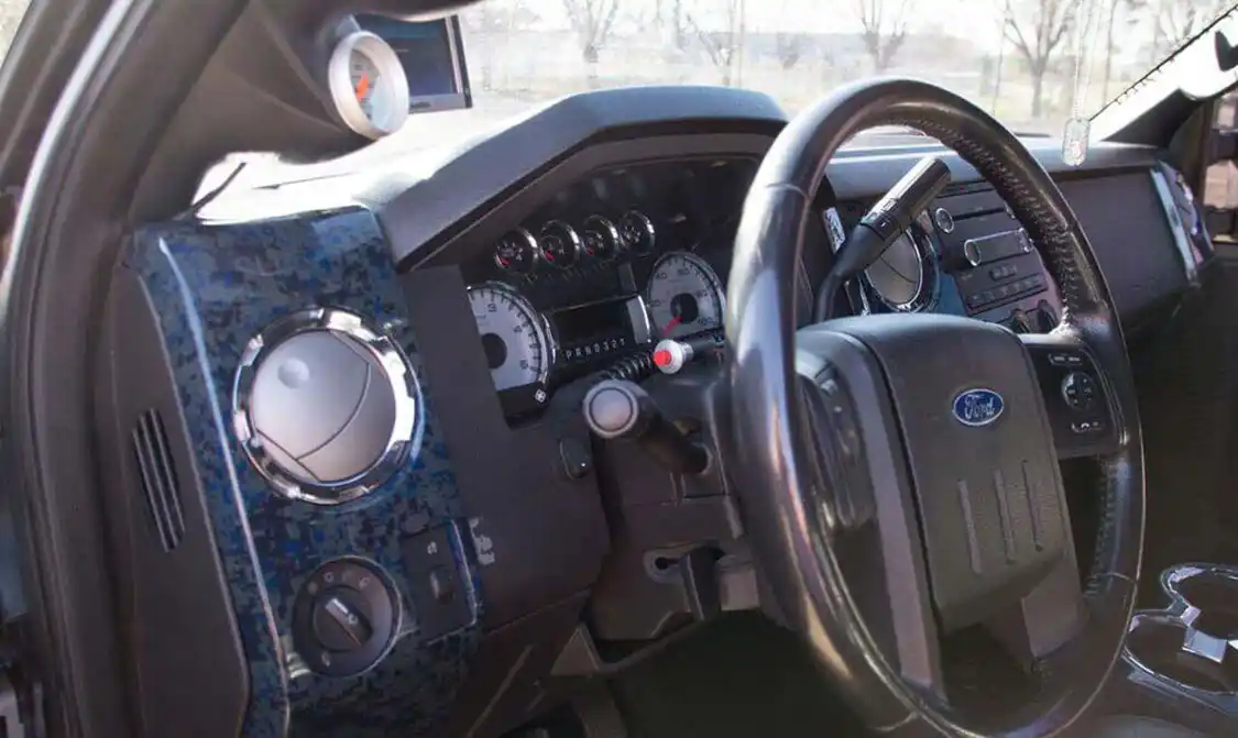 The interior of the truck has been kept pretty simple; beside the hydro-dipped digi-camo panels from <a href="https://www.mhp14.com/">Baltimore Hydrographics</a>, you'll find a DashDaq monitor for watching engine vitals, a couple 0-100psi gauges to watch boost and drive pressures, and a handheld nitrous switch for when the need arises.