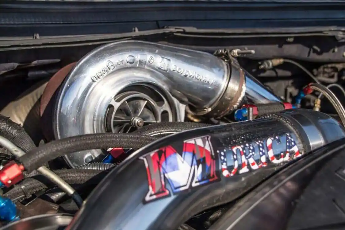 The polished 76mm turbocharger is mounted under the hood using a Maryland Performance Diesel single-turbo conversion kit. Not wanting to be limited on power by sticking with factory-style VGT compounds, the big S400 turbocharger moves more than enough air to support low-11-second quarter-mile times in a nearly 8,000-lb truck.