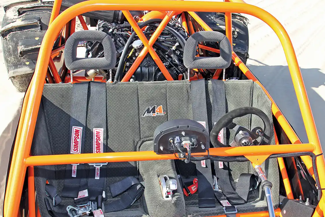 The cockpit’s sparse and built for racing but comes complete with <a href="https://www.simpsonraceproducts.com/">Simpson</a> 5-point harnesses to hold the driver and passenger securely into the custom formed aluminum seat.