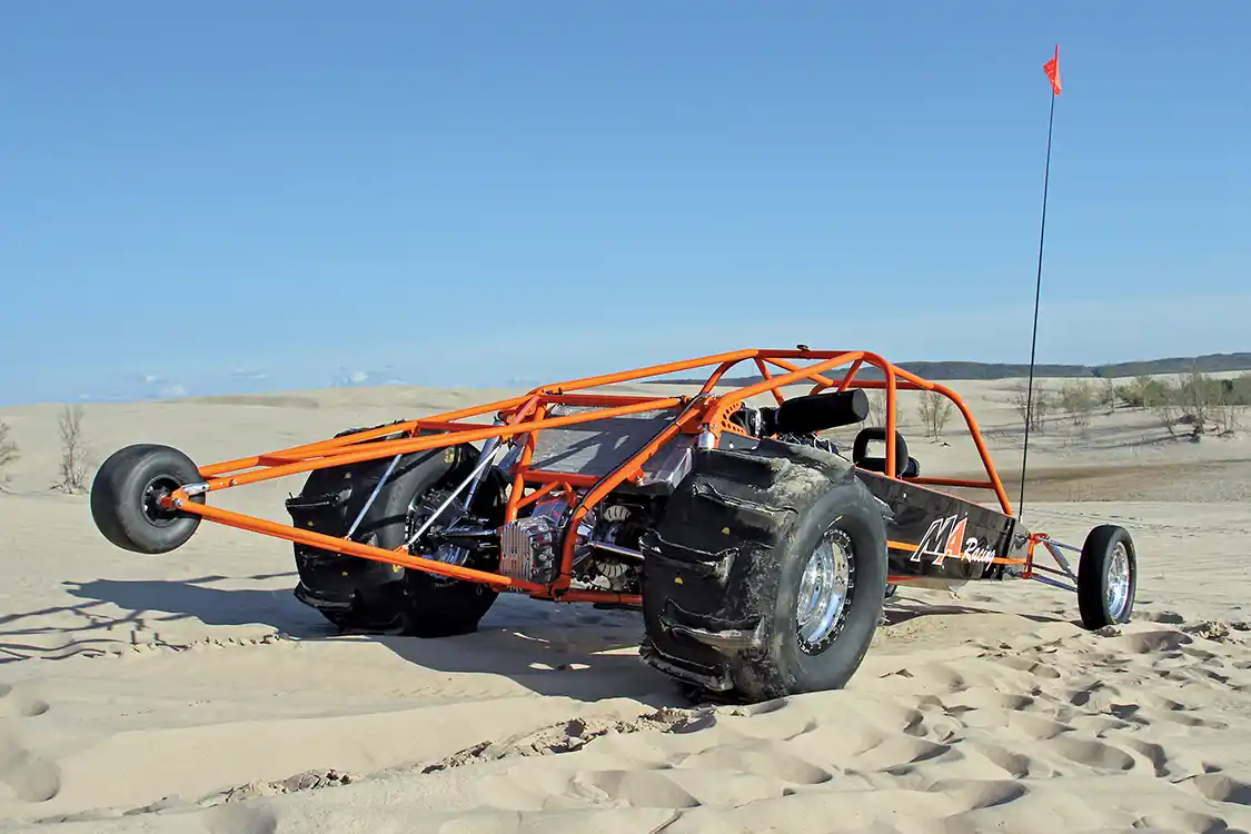 Looking at the buggy from the rear, you can see the massive paddle tires as well as the rear mounted radiator and quick-change differential. The tires seen in this picture are an older play set that the team has since replaced with a set that has larger paddles.