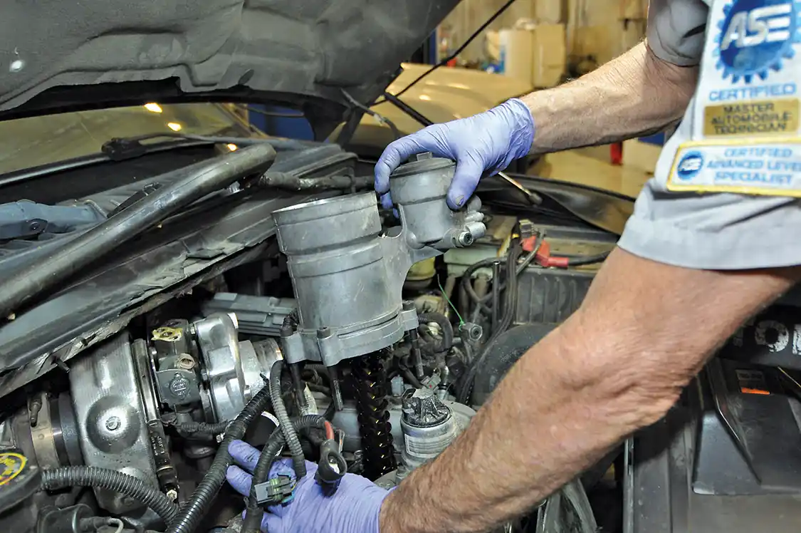 3. Mounted directly atop the oil cooler is the oil filter and fuel pressure regulator. This assembly needs to be removed to access the oil cooler but will also get in the way during turbo removal.